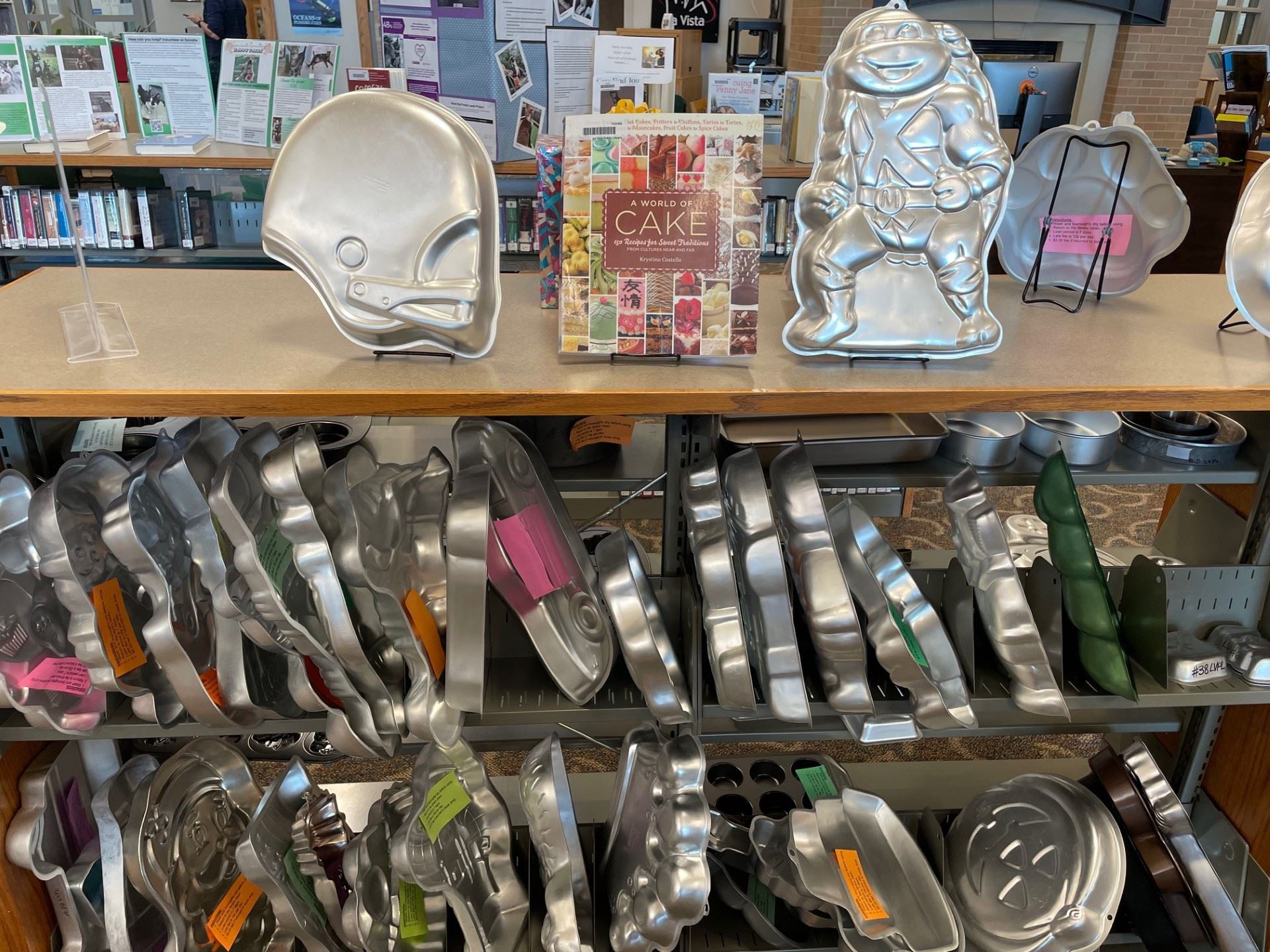 Cake pan collection displayed in library. 